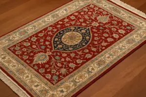 Traditional handwoven Hereke rug displayed in natural light, showcasing intricate Ottoman floral motifs and fine silk craftsmanship in a Turkish carpet store.